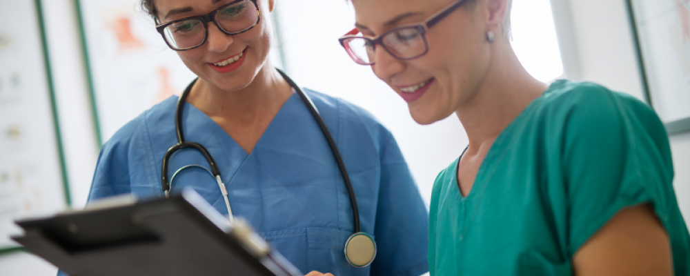 Two nurses happily discussing